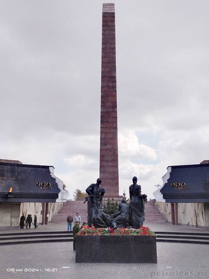 Скульптурная группа на центральной площади Монумента героическим защитникам Ленинграда и вид на стелу